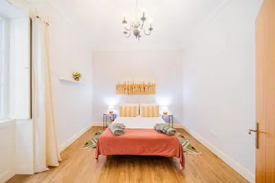 a bedroom with a bed and a chandelier at Casa na Ilha IV in Funchal