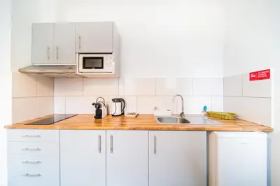 a kitchen with white cabinets and a sink at Casa na Ilha IV in Funchal