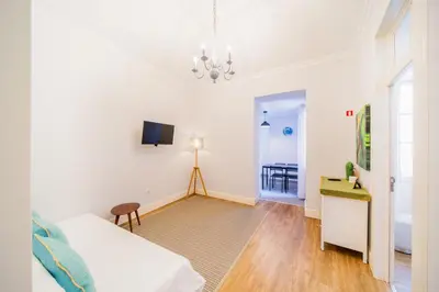 a bedroom with a bed and a desk and a tv at Casa na Ilha IV in Funchal