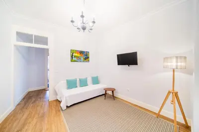 a room with a bed and a tv on a wall at Casa na Ilha IV in Funchal