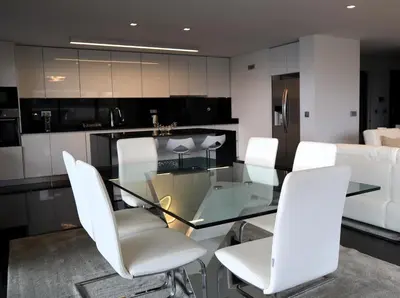 a dining room with a glass table and white chairs at Seaside XXI-10, By OP in Funchal