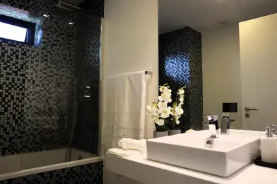 a bathroom with a white sink and a shower at Seaside XXI-10, By OP in Funchal