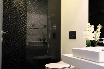 a bathroom with a shower and a toilet and a sink at Seaside XXI-10, By OP in Funchal