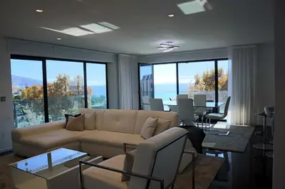 a living room with a couch and a table at Seaside XXI-10, By OP in Funchal