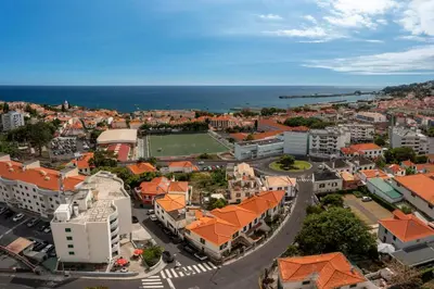 an aerial view of a city with buildings and the ocean at Casa Strelitzia by An Island Apart in Funchal
