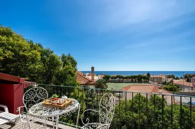 a table and chairs on a balcony with a view at Casa Strelitzia by An Island Apart in Funchal