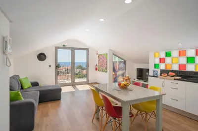 a kitchen and living room with a table and chairs at Casa Strelitzia by An Island Apart in Funchal