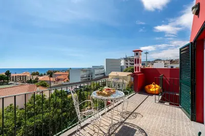 a balcony with a table and a pumpkin at Casa Strelitzia by An Island Apart in Funchal