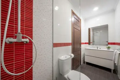 a bathroom with a toilet and a sink at Casa Strelitzia by An Island Apart in Funchal