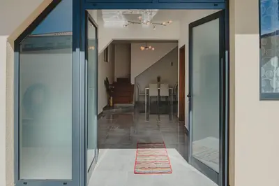 a hallway with glass doors leading into a house at Casa Estrelicia in Ponta do Sol