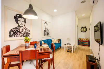 a living room with a table and a blue couch at Casa Da Avo Clementina in Funchal