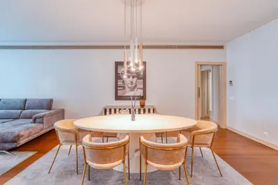 a dining room with a table and chairs at Suite BK - 3 Pools - Gym - AC - Huge Balcony in Funchal