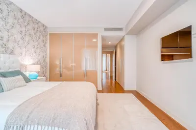 a bedroom with a large bed and a tv at Suite BK - 3 Pools - Gym - AC - Huge Balcony in Funchal