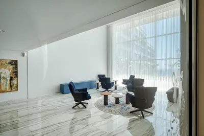 a waiting room with chairs and tables and a large window at Suite BK - 3 Pools - Gym - AC - Huge Balcony in Funchal