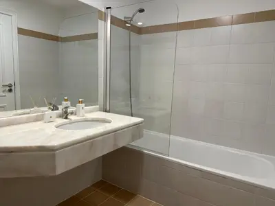 a bathroom with a sink and a shower and a tub at Tropical Garden in Caniço