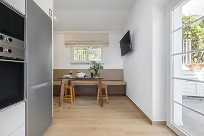 a small kitchen with a table and a window at Casas da Luz by Homie in Ponta do Sol