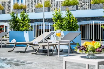 a table and chairs on a patio with a bowl of fruit at Casas da Luz by Homie in Ponta do Sol