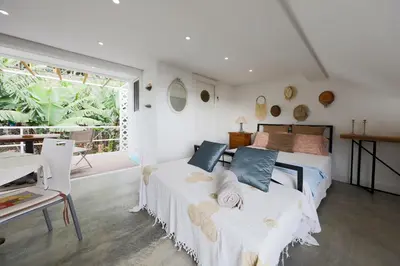 a bedroom with two beds and a large window at Baldeia - Oceanfront Apartments in Ponta do Sol