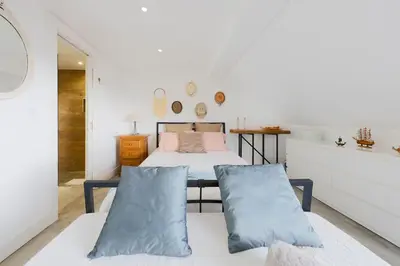 a bedroom with a bed and two pillows at Baldeia - Oceanfront Apartments in Ponta do Sol