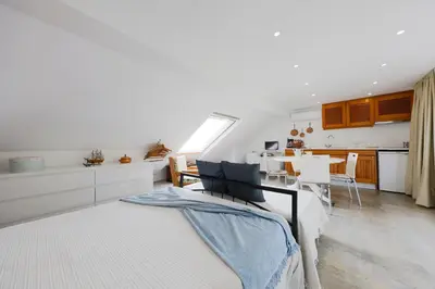 a kitchen and a living room with a bed in a room at Baldeia - Oceanfront Apartments in Ponta do Sol