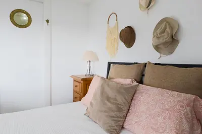 a bedroom with a bed with a pink blanket at Baldeia - Oceanfront Apartments in Ponta do Sol