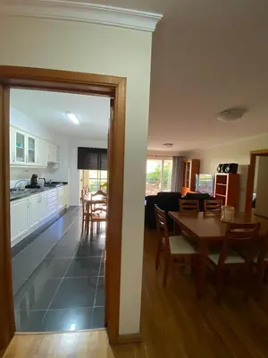 a kitchen and dining room with a table and chairs at Apartamento Costa Do Sol V in Funchal