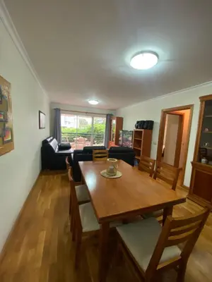 a living room with a wooden table and chairs at Apartamento Costa Do Sol V in Funchal
