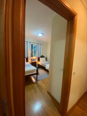 a doorway to a bedroom with two beds and a mirror at Apartamento Costa Do Sol V in Funchal
