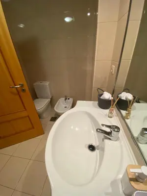 a bathroom with a white sink and a toilet at Apartamento Costa Do Sol V in Funchal