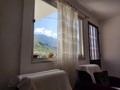 a window with a view of a mountain at Peaceful place in São Vicente in São Vicente