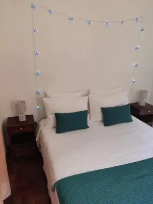 a bedroom with a large bed with two pillows at Peaceful place in São Vicente in São Vicente