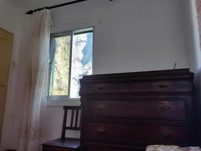 a bedroom with a dresser and a window at Peaceful place in São Vicente in São Vicente