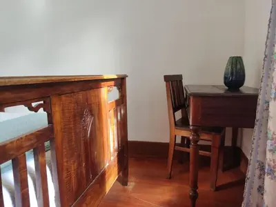 a room with a desk and a table and a chair at Peaceful place in São Vicente in São Vicente