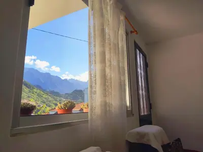 a window with a view of a mountain at Peaceful place in São Vicente in São Vicente