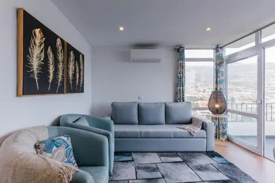 a living room with a couch and a chair at Fatima`s House in Funchal