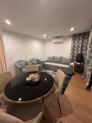 a living room with a table and chairs and a couch at Fatima`s House in Funchal