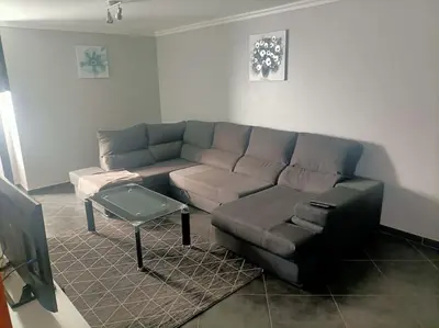 a living room with a couch and a table at Casa RuMa ao Sol in Ponta do Sol