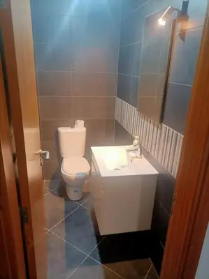 a bathroom with a toilet and a sink at Casa RuMa ao Sol in Ponta do Sol