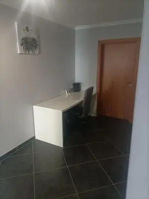 a room with a desk with a chair and a door at Casa RuMa ao Sol in Ponta do Sol
