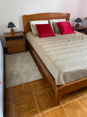 a bed with two red pillows on it in a room at Hollywood villa in Campanário