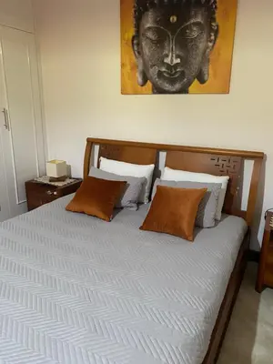 a bed with orange pillows and a picture of a woman at Hollywood villa in Campanário