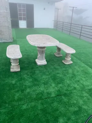 a table and two benches on a green field at Hollywood villa in Campanário