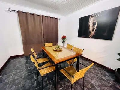 a dining room with a wooden table and chairs at Hollywood villa in Campanário