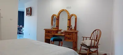 a bedroom with a dressing table and a mirror at Living Caboqueira in Funchal