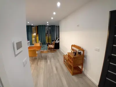 a living room with white walls and wooden floors at Living Caboqueira in Funchal