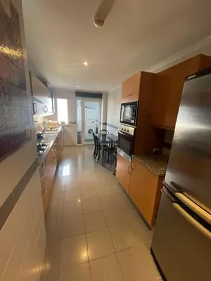 a kitchen with a stove top oven and a counter top at In Town View in Funchal