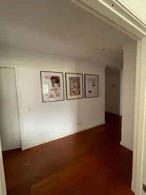 a hallway with four pictures on a white wall at In Town View in Funchal