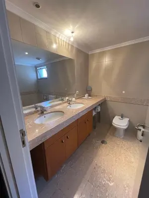 a bathroom with two sinks and a toilet at In Town View in Funchal