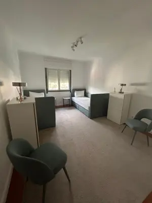 a room with a bed and chairs in it at In Town View in Funchal