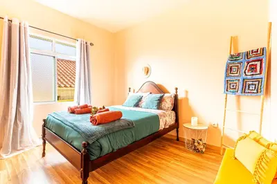 a bedroom with a bed and a window at Home Thomas in Lombada dos Marinheiros